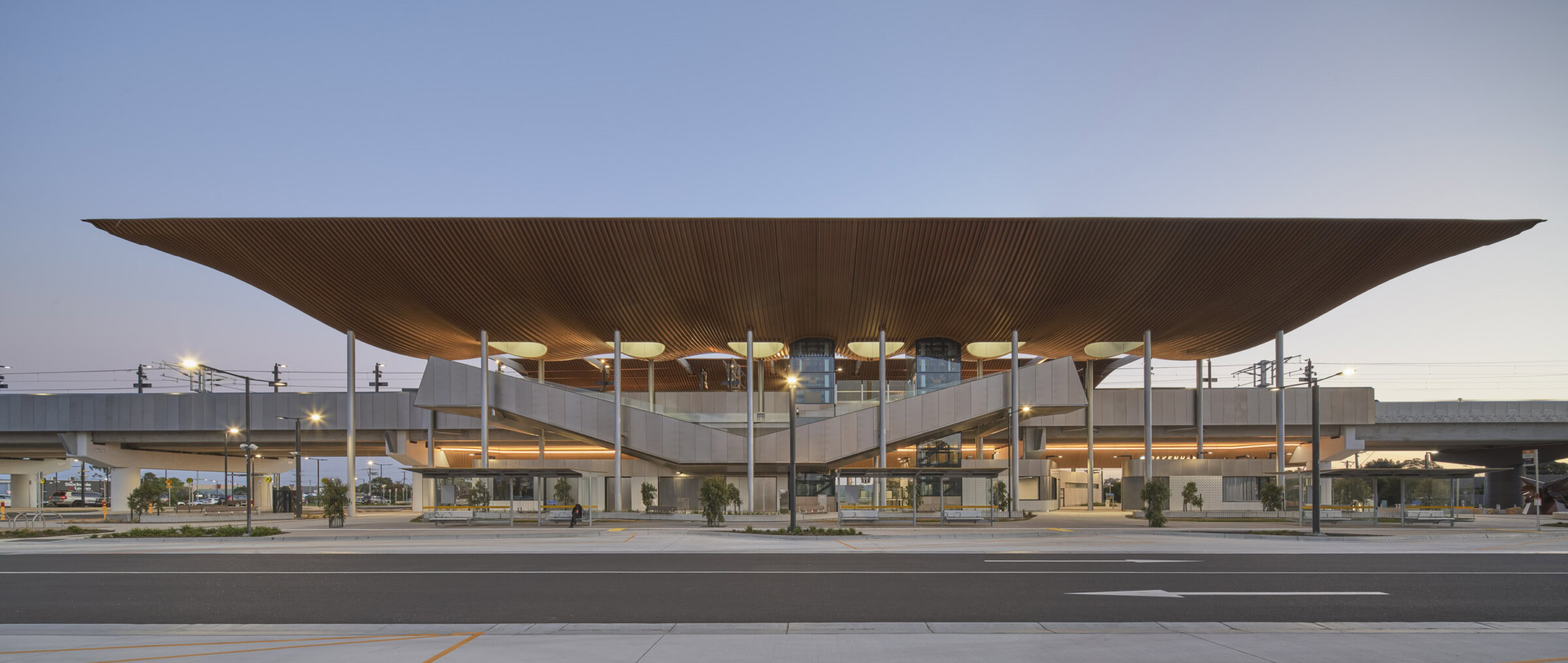 Pakenham Station Melbourne rail architecture with bronze roof, elevated platforms, and transparent civic gateway design