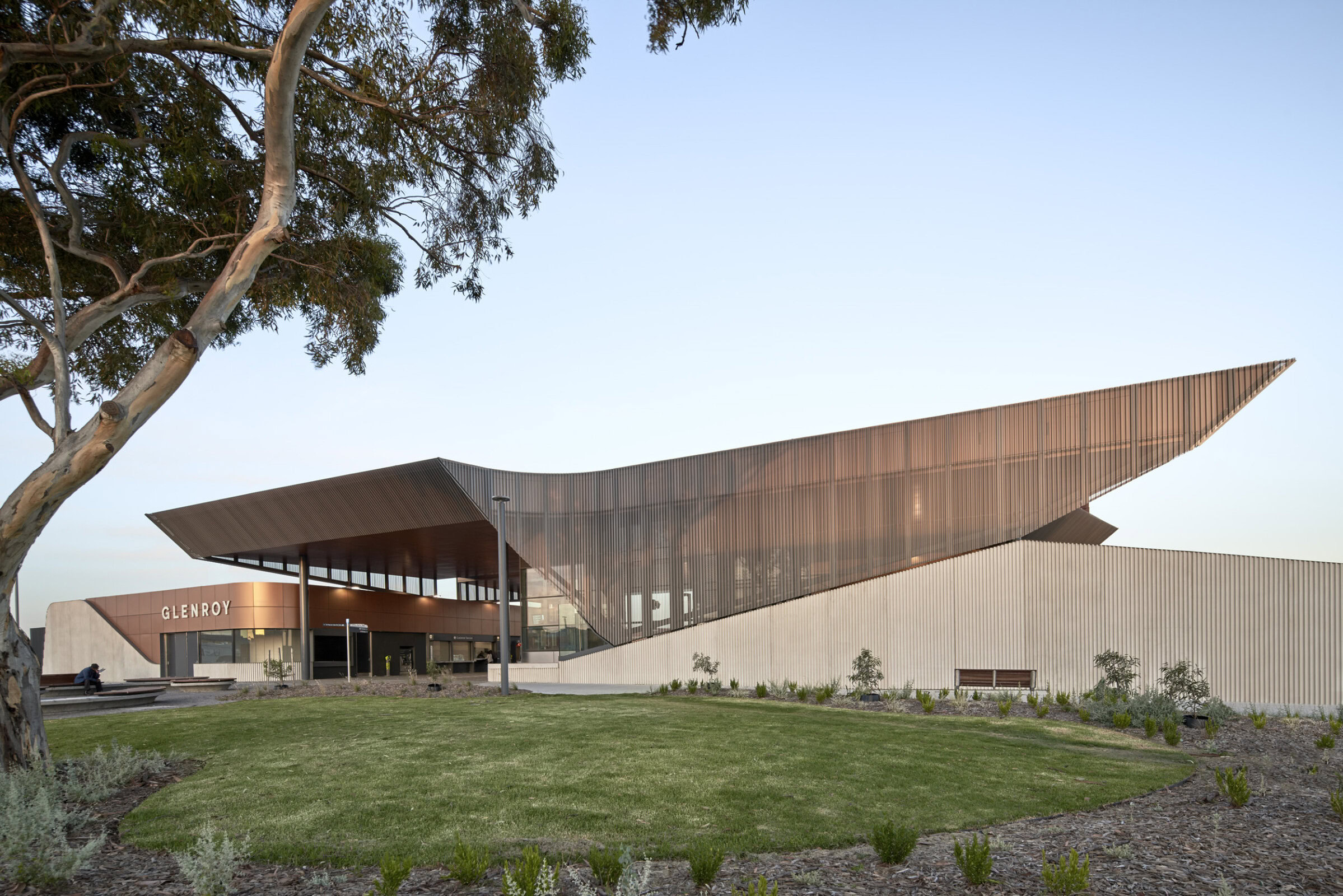 Exterior of Glenroy Station Melbourne rail architecture featuring angular roof and landscaped civic forecourt, part of Melbourne rail infrastructure upgrade by Genton