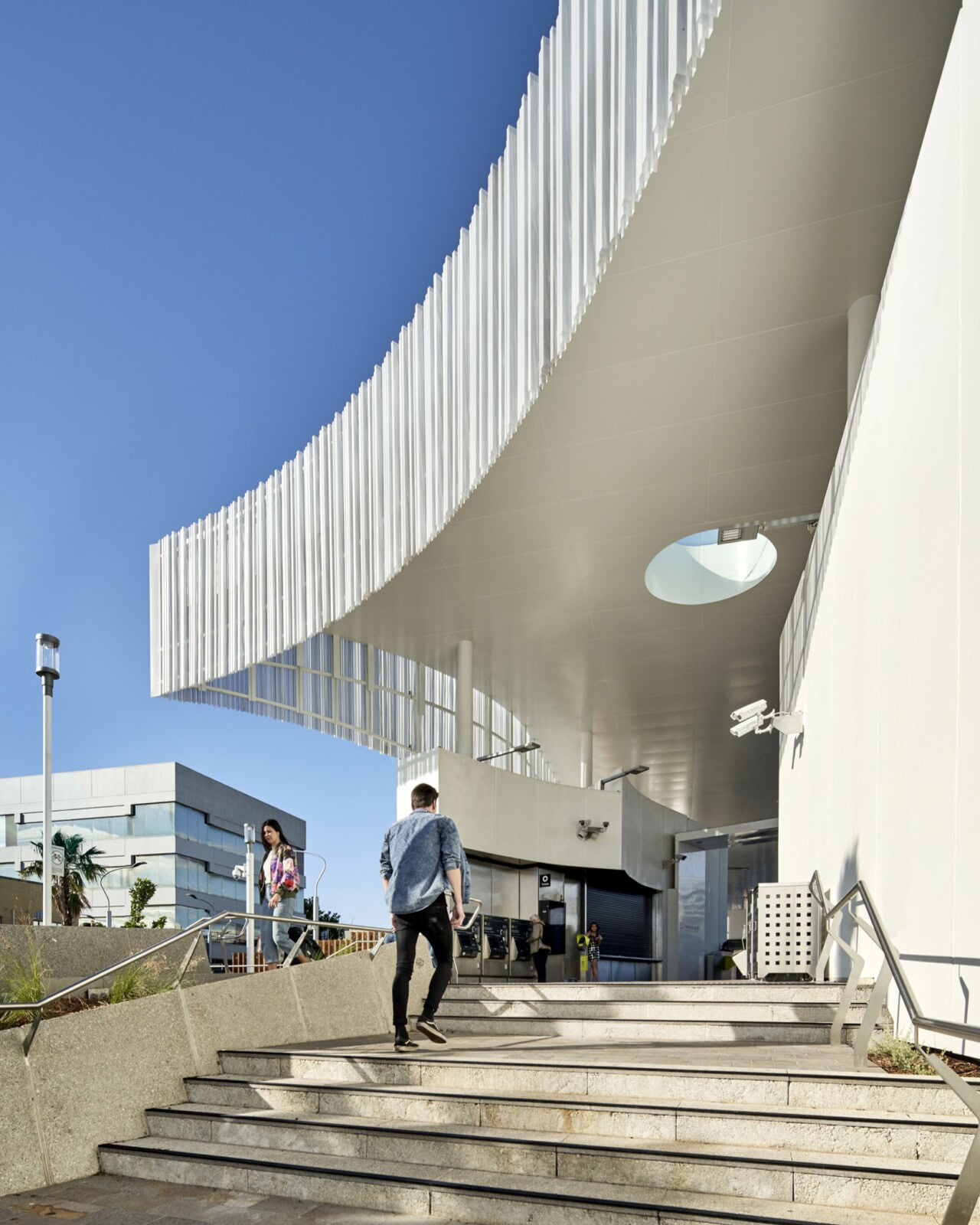Frankston Station by Genton – curved canopy and civic entrance staircase designed by one of the best rail architects in Australia.